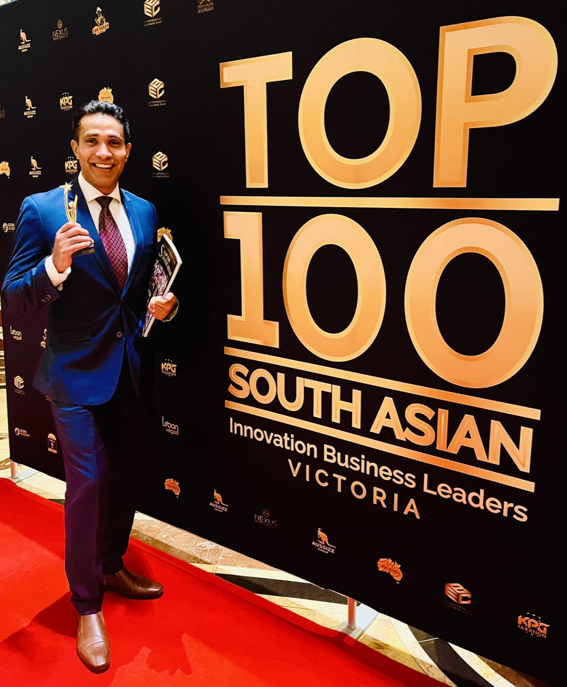 Manny Adhana receiving Top 100 South Asian Innovation Business Leaders Victoria 2023 trophy
